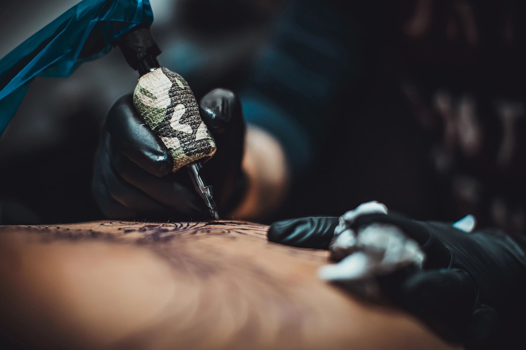 tattoo artist working black and gray realism